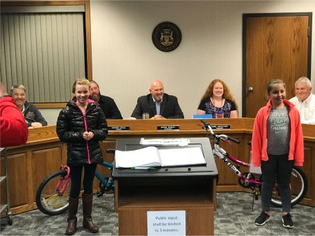 Children and their bicycles take center stage at a Board of Trustees' meeting.